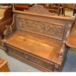 A later Victorian carved oak box settle, 125cm by 52cm by 103cm together with a Regency mahogany