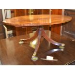 A mahogany oval coffee table on four splayed legs, 122cm diameter