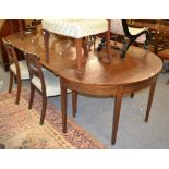 A George III mahogany dining table and six chairs