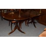 A Regency style mahogany twin-pedestal dining table with additional leaf
