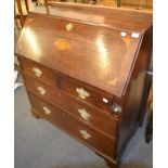 An 18th century inlaid oak bureau, the fall front with central shell pattera within conforming