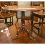 George III oak circular tilt top tripod table, 89cm by 69cm