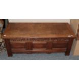 A 20th century oak blanket box with three moulded panels