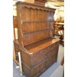 A reproduction oak dresser and rack