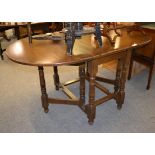 A reproduction oak gate leg dining table