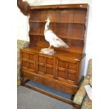 A mid 20th century oak sideboard with three cupboard doors, 134cm wide