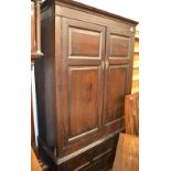 An 18th century oak clothes-press with later brass hanging rail, with two drawers