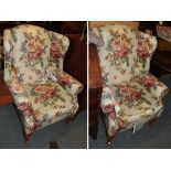 A pair of floral upholstered wing back arm chairs; together with a three-seater sofa in matching