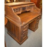 An early 20th century oak roll top desk labelled ''G.Dobson & Sons, Desk Agents, Leeds'', 125cm by