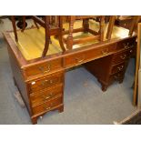 A 20th century mahogany leather inset pedestal desk, 140cm by 77cm by 77cm high