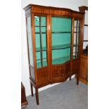 An Edwardian inlaid mahogany serpentine fronted display case, 123cm by 46cm by 176cm