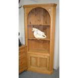 A pine freestanding corner cupboard