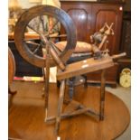 A 20th century oak spinning wheel