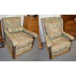 A pair of early 20th century carved oak armchairs, later recovered in floral fabric