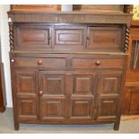 An early 18th century carved and panelled oak court cupboard, initialled T.H.M dated 1717 154cm by