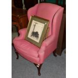 A mahogany framed wing back armchair