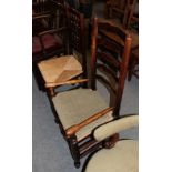 A 19th century elm ladder back low armchair, together with a spindle back armchair of similar