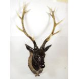 A Model of Red Deer head mount on faux shield with faux antlers, 14 points, widest span 69cm, height