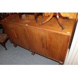 An oak four door sideboard, an oak cabinet with fall front, a pair of yew wood tripod tables, a