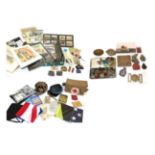 A Quantity of Militaria, including cap and other badges, cloth insignia,