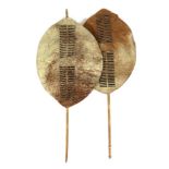 Two 20th Century Zulu Cow Hide Shields, each of brown roan colouring, of elliptical form,