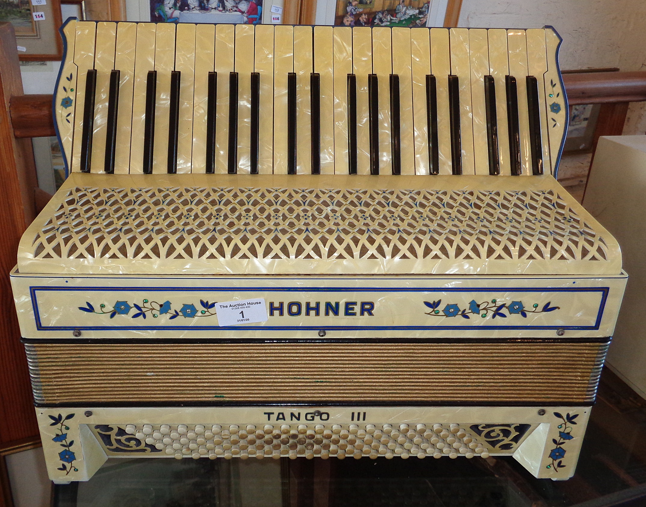 A Hohner Tango lll accordion in cream mother of pearl effect, good condition with case