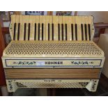 A Hohner Tango lll accordion in cream mother of pearl effect, good condition with case