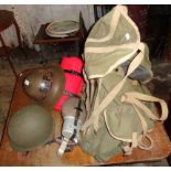 Tin helmet, WW2 army rucksack (1944), bed roll and flasks, and a U.S. helmet