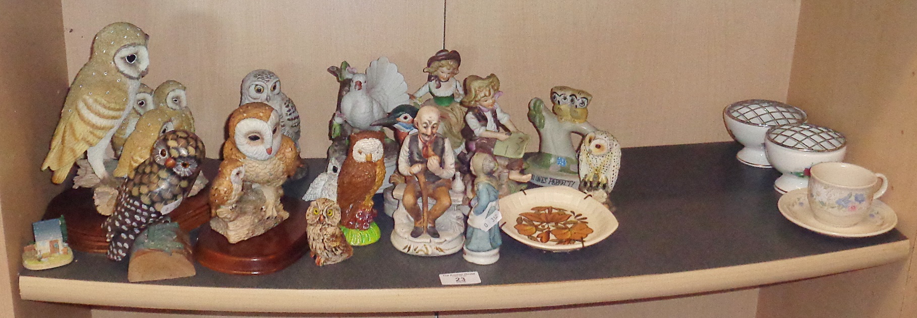 Shelf of assorted owl and other ornaments