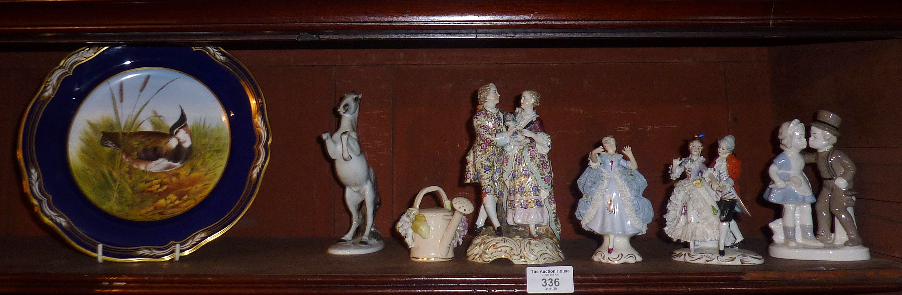 Three Continental porcelain figurines and other ceramics (shelf of)