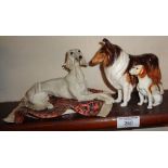 Royal Doulton figure of a Collie dog, a Continental porcelain figure of a Saluki on a Persian rug