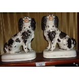 Pair of Staffordshire dogs in black and white on square bases, 20cm tall