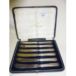 Set of six cased butter spreading knives with hallmarked silver handles