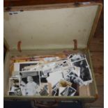 Vintage suitcase containing old black and white family photos, press photos and other ephemera
