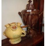 Marbled pottery tea urn and a Continental pottery earthenware vase with four spouts and two handles