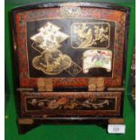 Chinese lacquered jewellery box or cabinet with seven drawers, finely painted in gold with scenes of