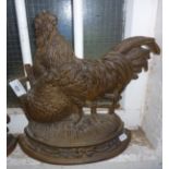 Cast-iron doorstop in the form of a chicken and a rooster