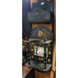 Victorian black and decorated lacquer hanging mirror having two shelves with turned supports and a