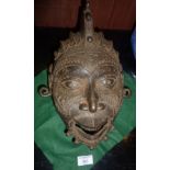 Tribal Art - cast & incised iron mask with open mouth & looped ear lobes