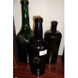 Three green glass antique bottles - one with applied seal marked as Trelaske, another marked under