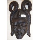 Carved African ebony mask with entwined snake