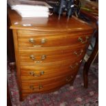 Mahogany bow fronted chest of four drawers with brass handles on four bracket feet