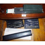 Two cased sets of drawing instruments and two slide rules