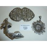 Ornate EPNS nurse's buckle, a Mexican silver sun pendant, and a heavy white metal Gothic type finger
