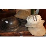 WW2 tin helmet and three Colonial polo helmets