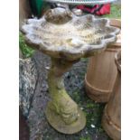 Stonework shell shaped bird bath on 'dolphin' plinth