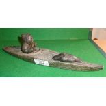 Inuit carved granite model of a kayak with seal hunter and seal, signed