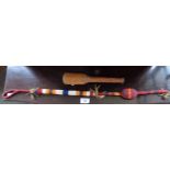 An American Indian beaded whip or dance stick together with a treen turned hardwood pestle