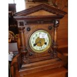 Victorian arch-topped German mantle clock with enamel and brass dial flanked by turned pillars