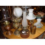 Five various brass oil lamps and pump action spray gun